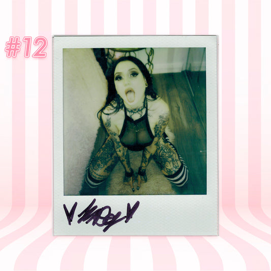Polaroid-style photo of a person with tattoos on a pink and white striped background