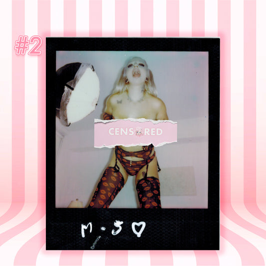 A Polaroid-style photo print centered on a pink striped background. The print shows a person with white hair wearing patterned stockings, with a pink torn-paper label reading 'CENSORED' across the middle.