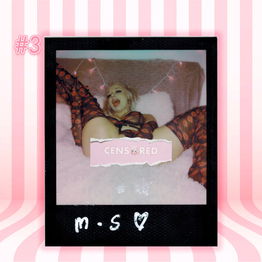 A Polaroid-style photo print centered on a pink striped background. The print shows a woman reclining on a white fluffy surface wearing sheer patterned stockings, with a torn-paper 'CENSORED' overlay and handwritten text at the bottom.