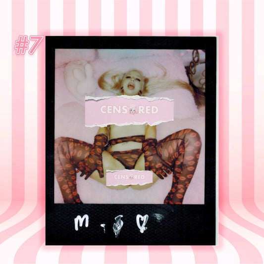 A Polaroid-style photo print centered on a pink and white striped background. The print shows a partially censored image with the text 'CENSURED' and 'CENSURED RED' over a pink-tinted scene.