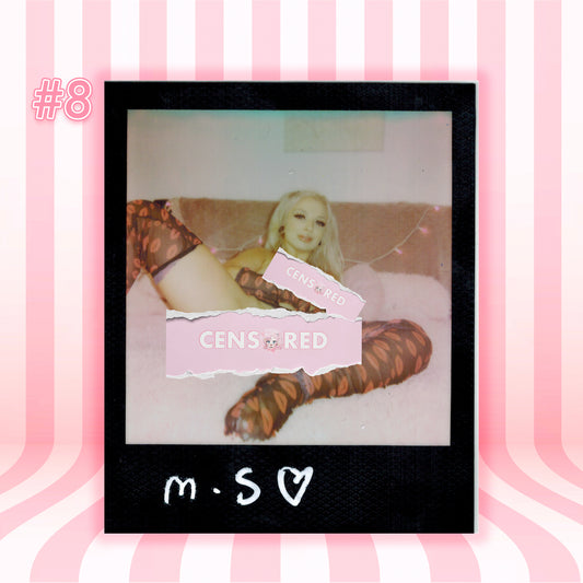 A Polaroid-style photo print centered on a pink striped background. The print shows a woman reclining on a bed wearing brown and black patterned stockings, with pink torn label overlays reading 'CENSORED' and 'CENSORED RED'.