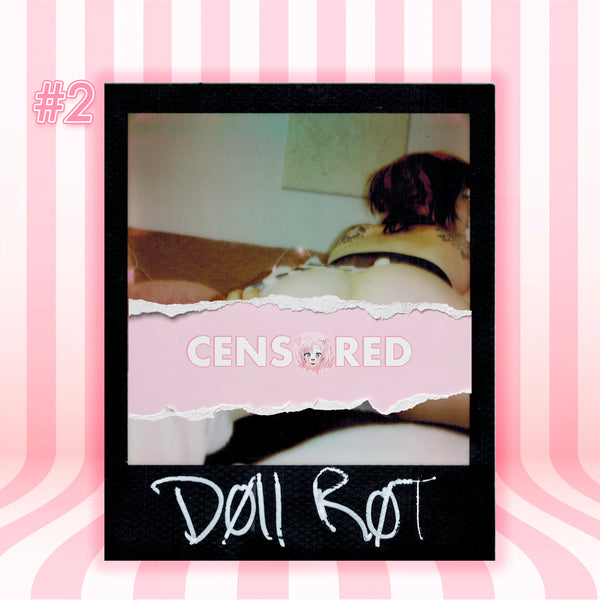 A Polaroid-style photo print with a black border on a pink striped background. The photo shows a person lying on a bed, with a torn pink paper overlay reading 'CENSORED' and handwritten text at the bottom reading 'Doll R0T'.
